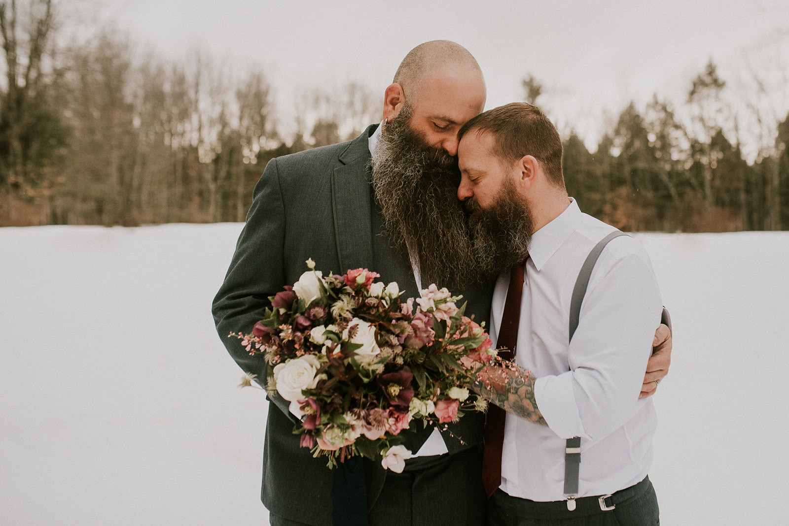 Couple smiles together holding stunning bouquet for an Earth friendly wedding